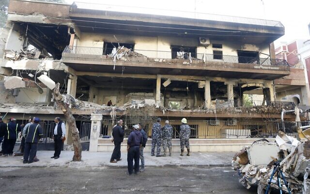 A picture taken on November 12, 2019 shows security forces and municipality workers outside a building targeted by an air strike in the Syrian capital Damascus' Mazze neighbourhood overnight. - Syrian state media reported that an Israeli strike hit the home of another Islamic Jihad militant, killing his son and another person. Israel did not immediately comment on that strike. Israel's military killed a commander of Palestinian militant group Islamic Jihad in a strike on his home in the Gaza Strip early, prompting retaliatory rocket fire and fears of a severe escalation in violence. (Photo by LOUAI BESHARA / AFP)