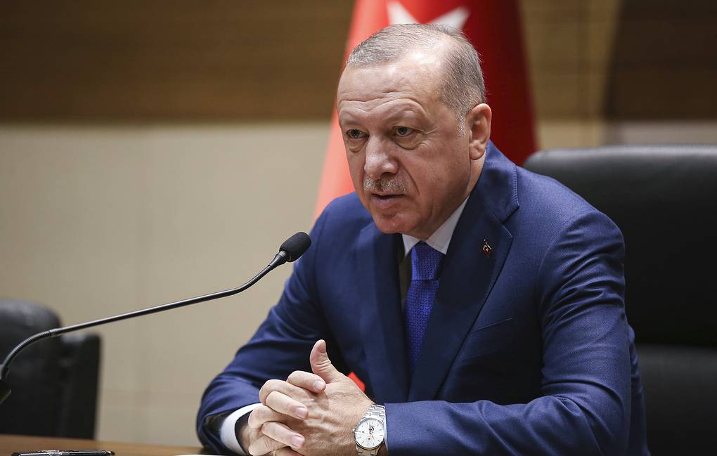 Turkey's President Recep Tayyip Erdogan speaks to the media before traveling to Berlin for a summit on Libya, in Istanbul, Sunday, Jan. 19, 2020. Erdogan expressed doubt Friday that Khalifa Hifter, the head of the self-styled Libyan National Army, would abide by the cease-fire. "This man is not a trust-worthy man," he told reporters in Istanbul. (Presidential Press Service via AP, Pool)