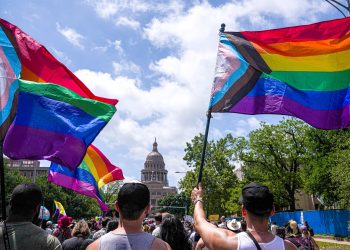 Activists wave progress pride flags as they and hundreds of others march toward the Capitol in a Queer Capitol March on Saturday, April 15, 2023, in Austin. Activists gathered to protest recent anti-LGBTQ legislation in Texas.