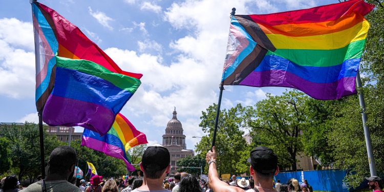 Activists wave progress pride flags as they and hundreds of others march toward the Capitol in a Queer Capitol March on Saturday, April 15, 2023, in Austin. Activists gathered to protest recent anti-LGBTQ legislation in Texas.