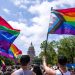 Activists wave progress pride flags as they and hundreds of others march toward the Capitol in a Queer Capitol March on Saturday, April 15, 2023, in Austin. Activists gathered to protest recent anti-LGBTQ legislation in Texas.