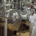 Wearing protective clothes, an Iranian security person walks at a part of the Uranium Conversion Facility, prior to the arrival of Iranian President Mohammad Khatami, just outside the city of Isfahan, 410 kilometers, south of the capital Tehran, Iran, Wednesday, March 30, 2005. The conversion facility in Isfahan reprocesses uranium ore concentrate, known as yellowcake, into uranium hexaflouride gas. The gas is then taken to Natanz and fed into the centrifuges for enrichment. (AP Photo/Vahid Salemi)