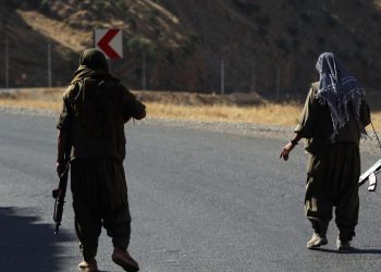 A member of the Kurdistan Workers' Party (PKK) carries an automatic rifle on a road in the Qandil Mountains, the PKK headquarters in northern Iraq, on June 22, 2018. - Hundreds of Iraqi Kurds marched Friday to protest Turkish strikes against the Kurdistan Workers' Party (PKK) after Turkey's President Recep Tayyip Erdogan said Ankara would press an operation against its bases. (Photo by SAFIN HAMED / AFP)        (Photo credit should read SAFIN HAMED/AFP via Getty Images)