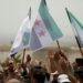 Displaced Syrians hold Free Syrian army flags during a protest calling for an end to the strikes and for Ankara to open the frontier at the Atmeh crossing on the Syrian-Turkish border, in Idlib governorate, Syria May 31, 2019. REUTERS/Khalil Ashawi