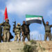 Turkish forces and Free Syrian Army members hold flags on Mount Barsaya, northeast of Afrin, Syria January 28, 2018. REUTERS/ Khalil Ashawi - RC1CD80C4D00