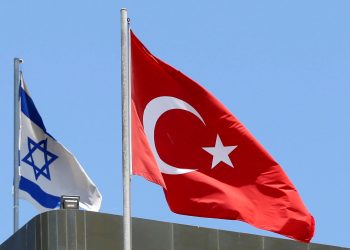 FILE PHOTO: A Turkish flag flutters atop the Turkish embassy as an Israeli flag is seen nearby, in Tel Aviv, Israel June 26, 2016.  REUTERS/Baz Ratner/File Photo