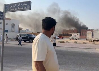 This frame grab taken from an AFPTV footage shows a man looking at smoke billowing after explosions in Qatar's capital Doha on September 9, 2025. An Israeli military official told AFP that the military had carried out air strikes on Doha on September 9 in an operation targeting senior leaders of Palestinian militant group Hamas. (Photo by Jacqueline PENNEY / AFPTV / AFP) (Photo by JACQUELINE PENNEY/AFPTV/AFP via Getty Images)