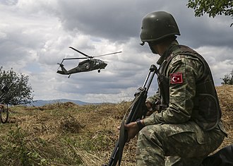 A Turkish soldier, with Multinational Battle Group-East, watches as a UH-60 Black Hawk gets ready to land after receiving a 9-line call for a simulated casualty. U.S. and NATO forces have contributed to the United Nations-mandated peacekeeping mission in Kosovo since June 1999. (Photo by Staff Sgt. Donna Davis, Multinational Battle Group-East public affairs)