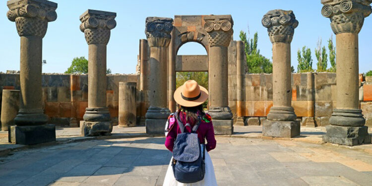 Female Traveler Visiting the Zvartnots Cathedral, UNESCO World Heritage Site in Armavir Province of Armenia