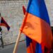 FILE - Armenians hold their national flag during a ceremony to commemorate the mass killings of Armenians by the Ottoman Empire, in Jerusalem, Israel, Friday, April 24, 2015. (AP Photo/Oded Balilty, File)