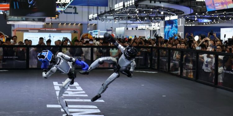 Humanoid robots by Unitree Robotics demonstrate kickboxing during the 2026 World Robot Conference, in Beijing, China, August 19, 2026. REUTERS/Tingshu Wang