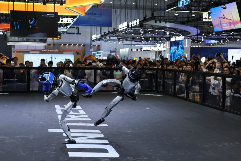 Humanoid robots by Unitree Robotics demonstrate kickboxing during the 2026 World Robot Conference, in Beijing, China, August 19, 2026. REUTERS/Tingshu Wang