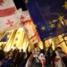 Protesters wave Georgian national and European flags during a demonstration outside the parliament building as they protest against a draft bill on "foreign influence" in Tbilisi on April 17, 2024. Thousands rallied in Georgia on April 17, 2024 after lawmakers advanced a controversial "foreign influence" law that opponents say will undermine Tbilisi's longstanding European aspirations. (Photo by Giorgi ARJEVANIDZE / AFP)